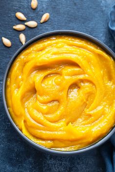 homemade pumpkin puree in a bowl with nuts on the side and text overlay