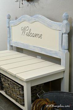 a white bench with baskets underneath it and the words welcome written on its back side