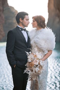 a bride and groom standing next to each other