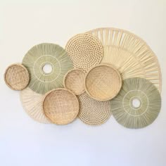 a group of woven baskets hanging on the wall