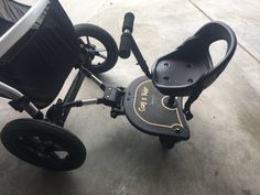 a baby stroller with wheels on the ground