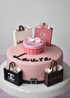 there is a pink cake with bags on it