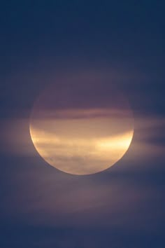 the sun is setting in front of some clouds as it passes through the sky,