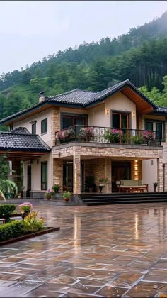 a large house sitting on top of a lush green hillside