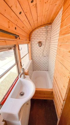 a bathroom with a sink, tub and window