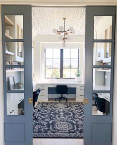 an open door leading to a home office with a rug on the floor and desk