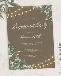 an elegant engagement party with greenery and lights on the front, in brown paper