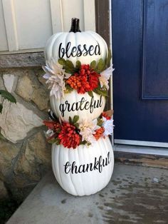 a white pumpkin decorated with flowers and words