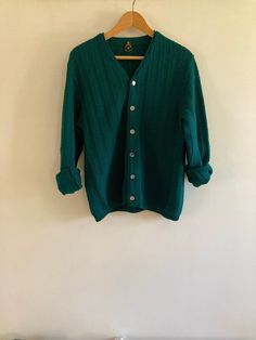 Fabulous vintage Ren-Dale knit cardigan in rich hunter green. The shade was hard to capture, just beautiful in person. Featuring a beautiful striped knit and finished with mother-of-pearl style buttons, this virgin wool cardigan is a perfect staple for spring and fall.  No flaws to note.  Marked a size Medium, I believe this is a men's sweater but would work for any gender.  Visit the Clothes | Shoes | Bags section for more handsome vintage menswear: https://www.etsy.com/ca/shop/LotusRoadVintage?section_id=27662622 Please visit my shop to see more gorgeous quality vintage items for your modern home: https://www.etsy.com/ca/shop/LotusRoadVintage?ref=seller-platform-mcnav Exciting news! Lotus Road Vintage has expanded and has launched a sister shop featuring only vintage print advertising. P Classic Green Wool Cardigan, Vintage Green Knit Outerwear, Green Wool Knitted Cardigan, Vintage Green Cardigan For Fall, Classic Green Textured Knit Sweater, Vintage Green Long Sleeve Cardigan, Vintage Green Knit Cardigan, Vintage Green Knit Tops, Green Vintage Knit Cardigan