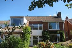 the house is surrounded by trees and bushes