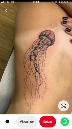 a woman's stomach with a jellyfish tattoo on it