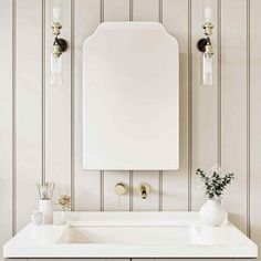 a white sink sitting under a bathroom mirror next to a wall mounted faucet