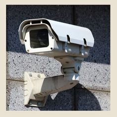 a security camera mounted on the side of a building