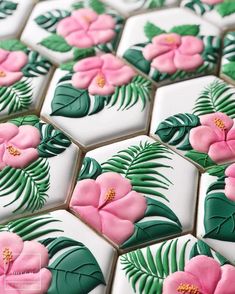 an image of some pink flowers and green leaves on white tiled tiles with the text down town doughnuts follow