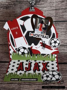 a card with an image of a soccer ball and the word ajax on it, hanging from a string