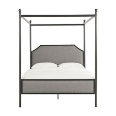 an iron bed frame with white sheets and pillows on the bottom, against a white background