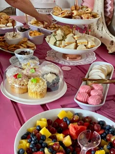 a table filled with lots of different types of desserts and pastries on plates