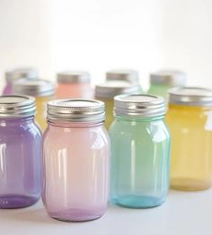 there are many different colored mason jars lined up in the same color as each other