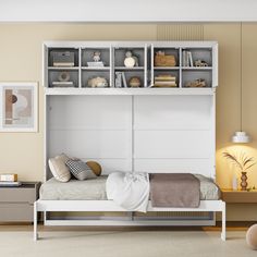 a white bed sitting under a book shelf next to a wall mounted lamp and dresser