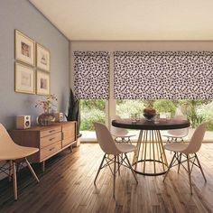 a dining room with blue walls and wooden floors