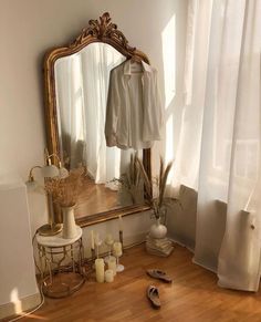 a mirror and some shoes on a wooden floor