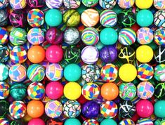 many different colored balls are arranged together in this photo, and one is full of them