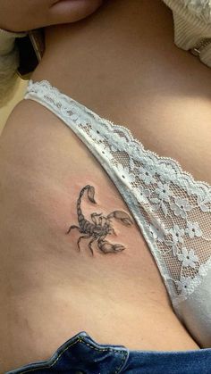 a woman with a scorpion tattoo on her stomach