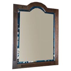 a mirror that is on top of a wooden frame with blue and white flowers around it