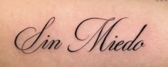 a tattoo with the word'un medd'written in cursive writing