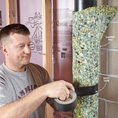 a man is working on some kind of bird feeder