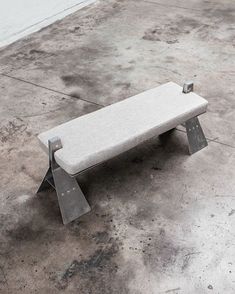 a concrete bench sitting on top of a cement floor