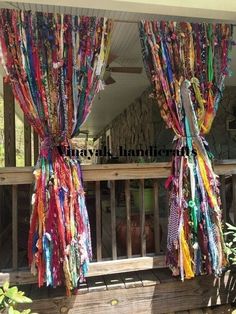 an outdoor area with curtains made out of ties