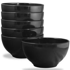 a stack of black bowls sitting next to each other