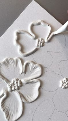 a close up of a piece of paper with flowers on it and a pair of scissors