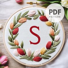 the letter s is surrounded by flowers and leaves