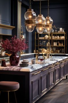 an elegant kitchen with marble counter tops and brass fixtures, hanging lights over the island