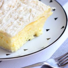 a piece of cake sitting on top of a white and black plate next to a fork