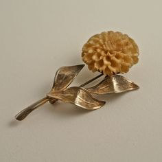 "This is a very nice gold filled Chrysanthemum Brooch.  It stands at 2 1/2\" tall and features a gold filled stem with three textured leaves that are each 1\" long and a circular disc that is 3/4\" across.  Upon this disc sits a hand carved Chrysanthemum flower that measures 1\" across.  The flower is beautifully carved with each petal well represented.  I  am not completely sure what the material of the flower is, it may be bone or and early type of plastic like celluloid.  The flower looks lik Types Of Plastics, Chrysanthemum Flower, Maltese Cross, Dream Board, Chrysanthemum, Makers Mark, Clip On Earrings, Brooch Pin, Brooches