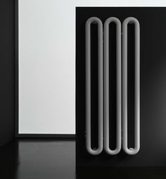 a white radiator sitting on top of a black table next to a wall