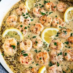 a skillet filled with shrimp and lemons