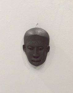 a black mask hanging on the wall