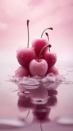 three cherries floating on top of water in the middle of a pink cloud filled sky