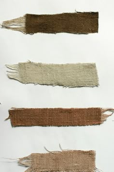 four pieces of cloth with fringes on them