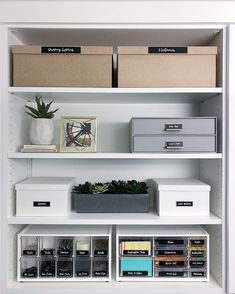 the shelves are organized with boxes, file folders and other office supplies on them