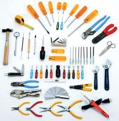 various tools are arranged in a circle on a white surface, including pliers and wrenches