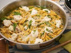 a pan filled with pasta and cheese on top of a table