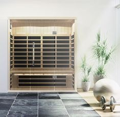 an indoor steam sauna is shown in this image with potted plants on the far side