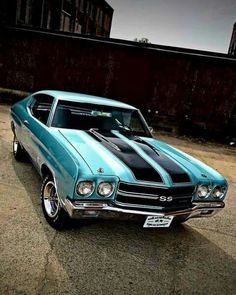 a blue and black muscle car parked on the street