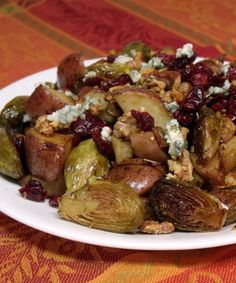 brussel sprouts with cranberries and walnuts on a white plate