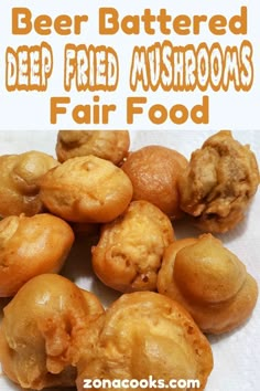 a pile of fried mushrooms sitting on top of a white paper towel with text overlay that reads, beer battered deep fried mushrooms fair food